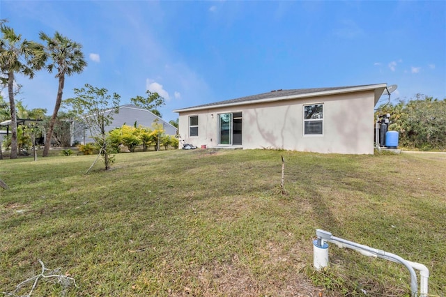 rear view of house with a yard