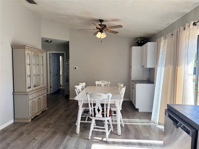 dining space with ceiling fan and dark hardwood / wood-style flooring