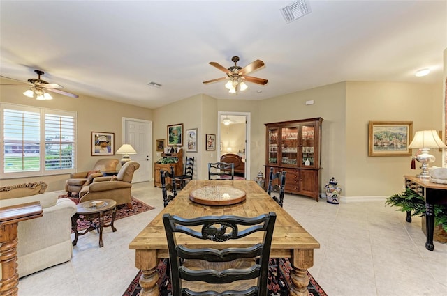 tiled dining room featuring ceiling fan