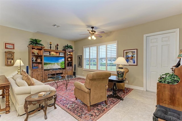 tiled living room with ceiling fan