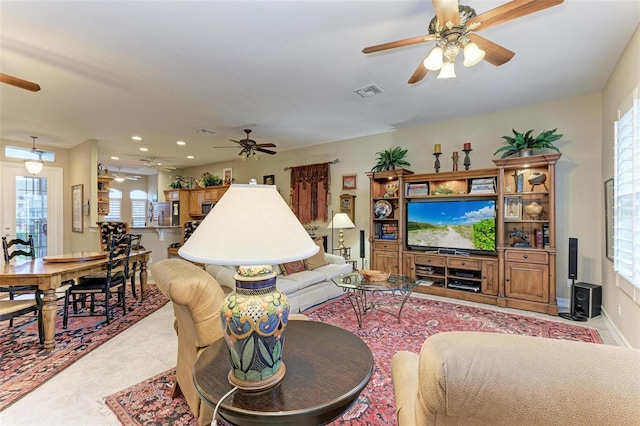 tiled living room with ceiling fan