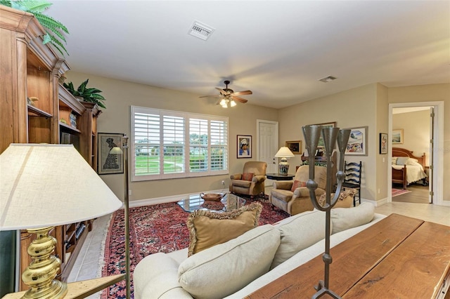 tiled living room featuring ceiling fan