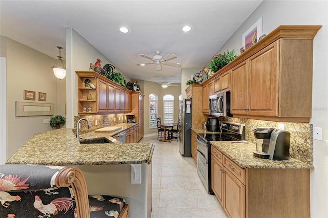 kitchen featuring kitchen peninsula, ceiling fan, appliances with stainless steel finishes, tasteful backsplash, and sink