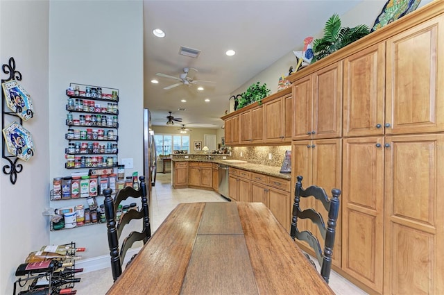 kitchen featuring kitchen peninsula, ceiling fan, tasteful backsplash, dishwasher, and light stone counters