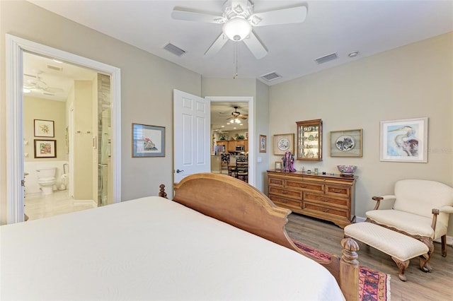 bedroom with ceiling fan, light hardwood / wood-style floors, and ensuite bathroom