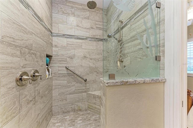 bathroom with tiled shower