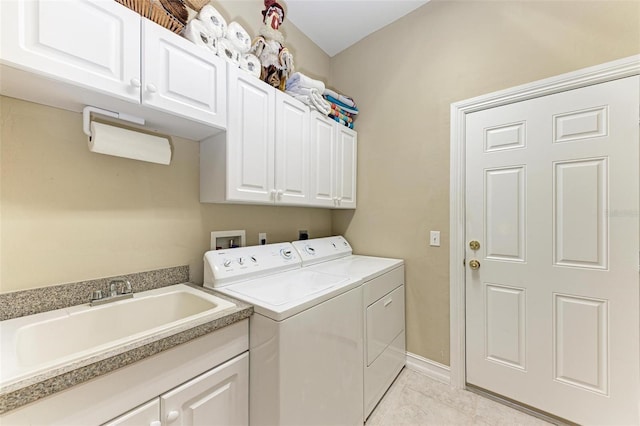 laundry area featuring cabinets, sink, and independent washer and dryer