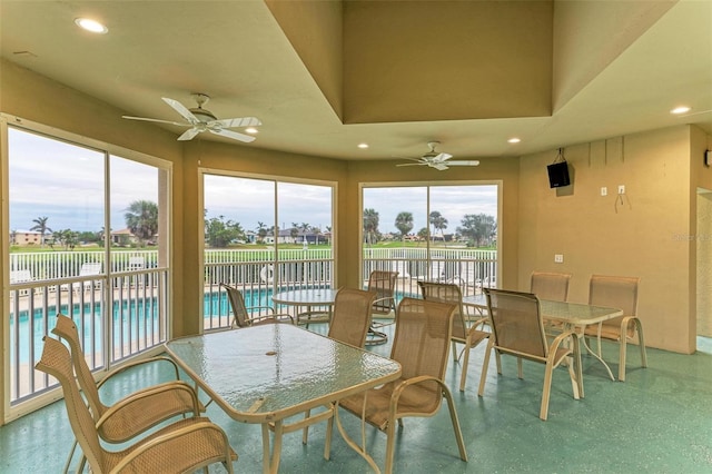 sunroom / solarium featuring ceiling fan