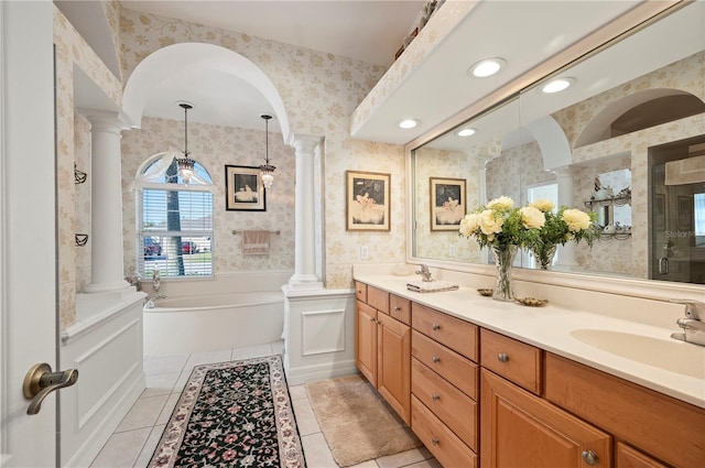 bathroom featuring tile patterned floors, plus walk in shower, vanity, and ornate columns