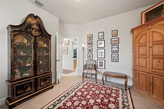 sitting room featuring light colored carpet