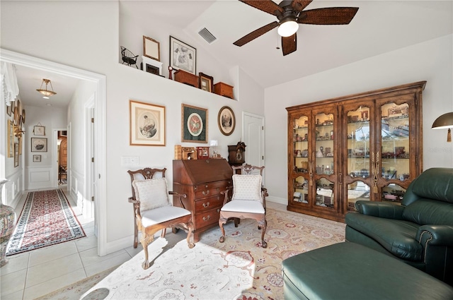 sitting room with lofted ceiling, ceiling fan, and light tile patterned flooring