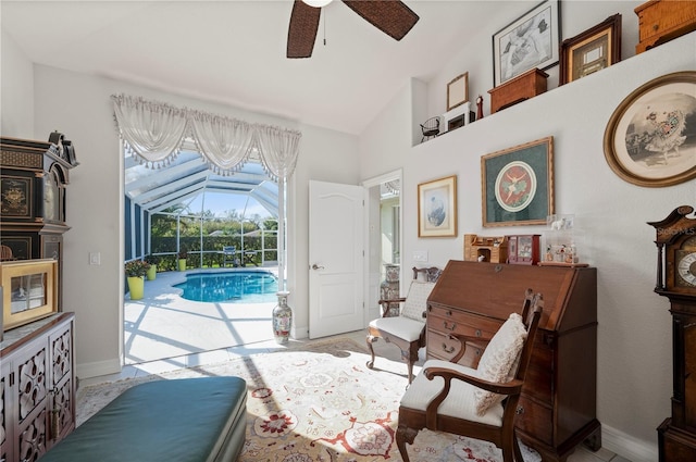 sitting room featuring ceiling fan, vaulted ceiling, and a pool