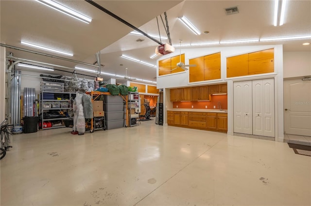 garage with a garage door opener and sink