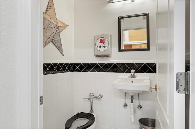 bathroom with tile walls and sink