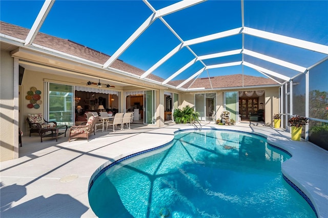 view of pool featuring ceiling fan, a lanai, and a patio