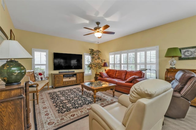 tiled living room with ceiling fan and a wealth of natural light