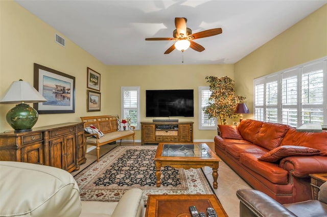 living room featuring ceiling fan and light tile patterned flooring