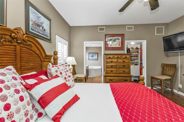 bedroom with ceiling fan, dark hardwood / wood-style flooring, and connected bathroom