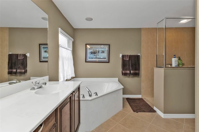 bathroom with tile patterned flooring, separate shower and tub, and vanity