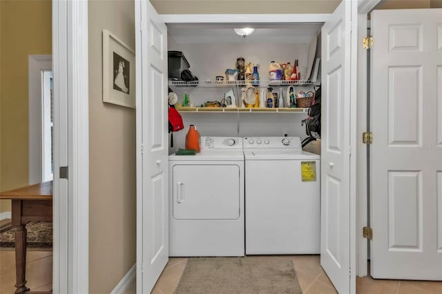 clothes washing area with separate washer and dryer and light tile patterned floors