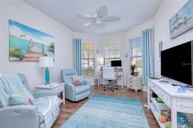 office area with dark wood-type flooring and ceiling fan