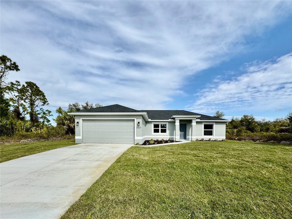 single story home featuring a garage and a front yard