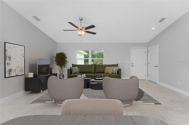 tiled living room featuring ceiling fan and lofted ceiling