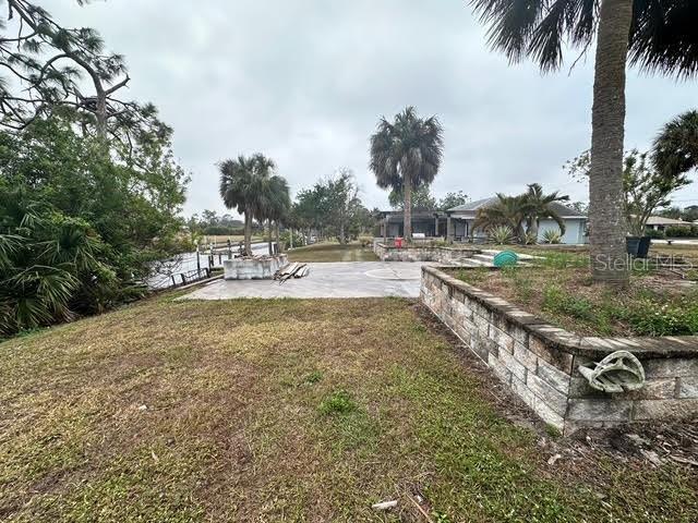 view of yard featuring a patio and a water view