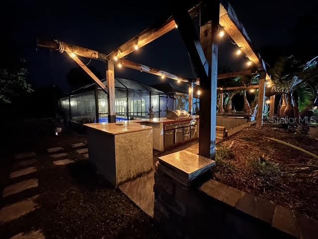 yard at night with an outdoor kitchen