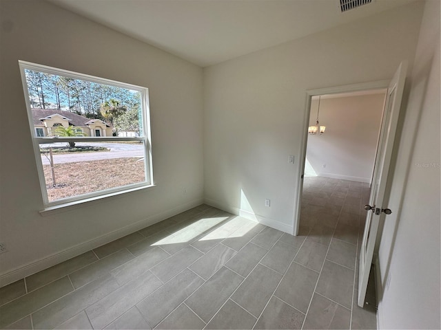 spare room featuring visible vents and baseboards