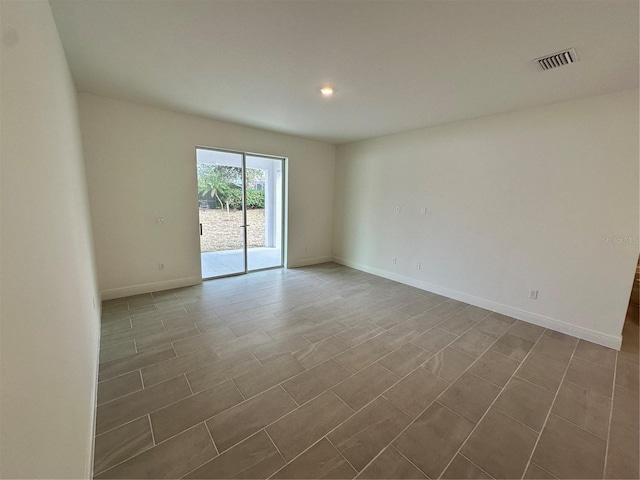 unfurnished room with recessed lighting, visible vents, and baseboards