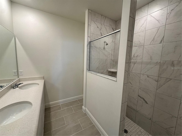 bathroom featuring walk in shower, a sink, and baseboards