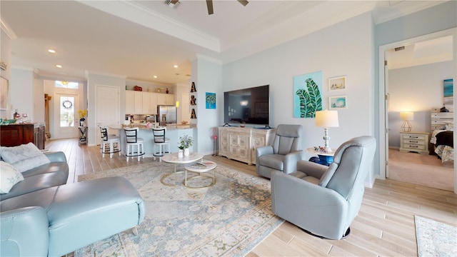 living room with ceiling fan and crown molding