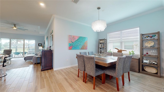 dining room featuring ceiling fan with notable chandelier, light hardwood / wood-style floors, and crown molding