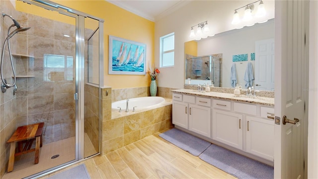 bathroom featuring ornamental molding, vanity, and shower with separate bathtub