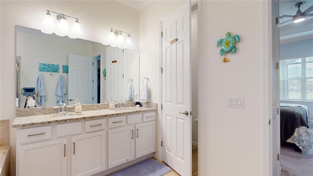 bathroom with vanity, ceiling fan, and crown molding