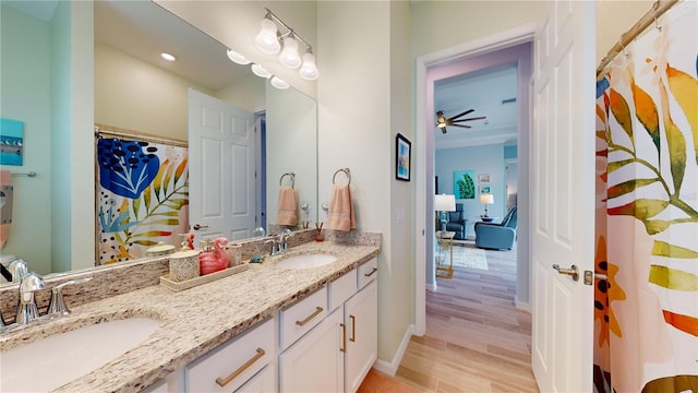 bathroom with wood-type flooring, vanity, and ceiling fan