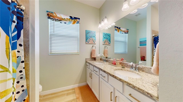 bathroom featuring toilet, tile patterned flooring, and vanity