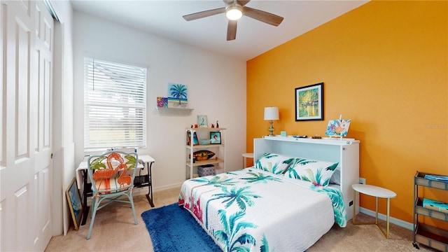 carpeted bedroom with ceiling fan and a closet