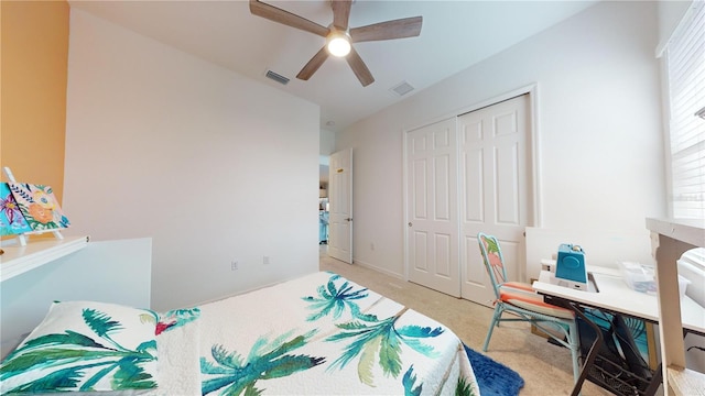 carpeted bedroom featuring ceiling fan and a closet