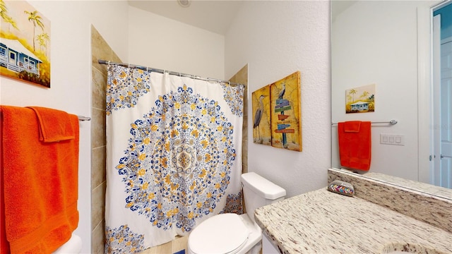 bathroom with toilet and a shower with shower curtain