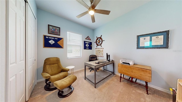 carpeted office space with ceiling fan