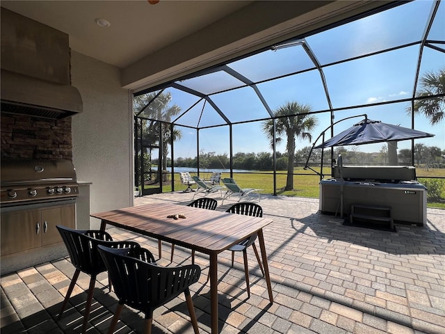 view of patio / terrace featuring a lanai, a hot tub, area for grilling, and grilling area