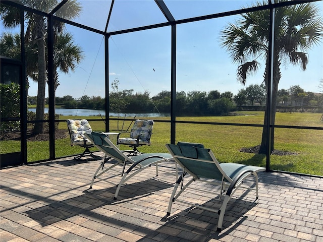 sunroom / solarium featuring a water view