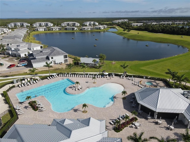 view of pool featuring a patio and a water view