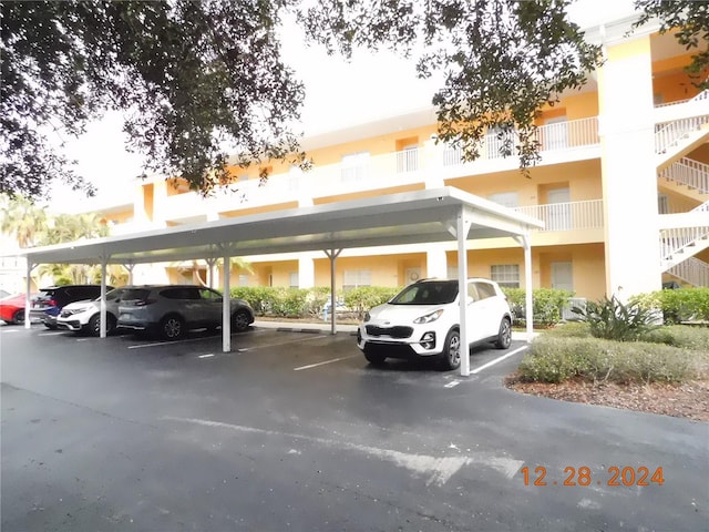 view of vehicle parking featuring a carport