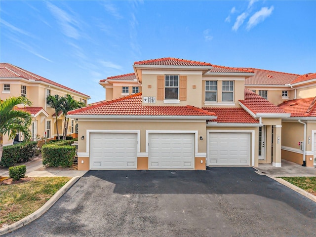 mediterranean / spanish-style house with a garage