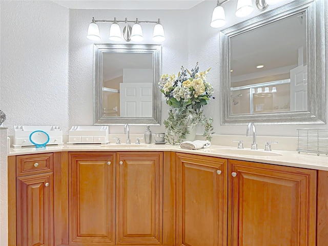 bathroom with vanity and a shower with shower door