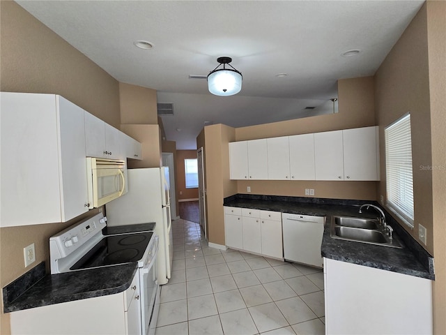 kitchen with white cabinetry, light tile patterned flooring, white appliances, and sink