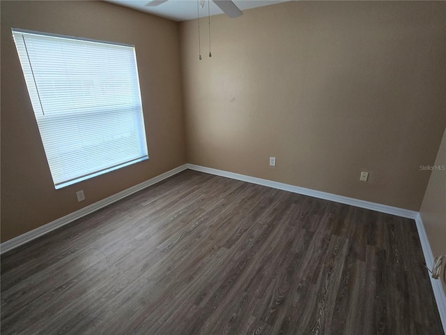 empty room with ceiling fan and dark hardwood / wood-style floors